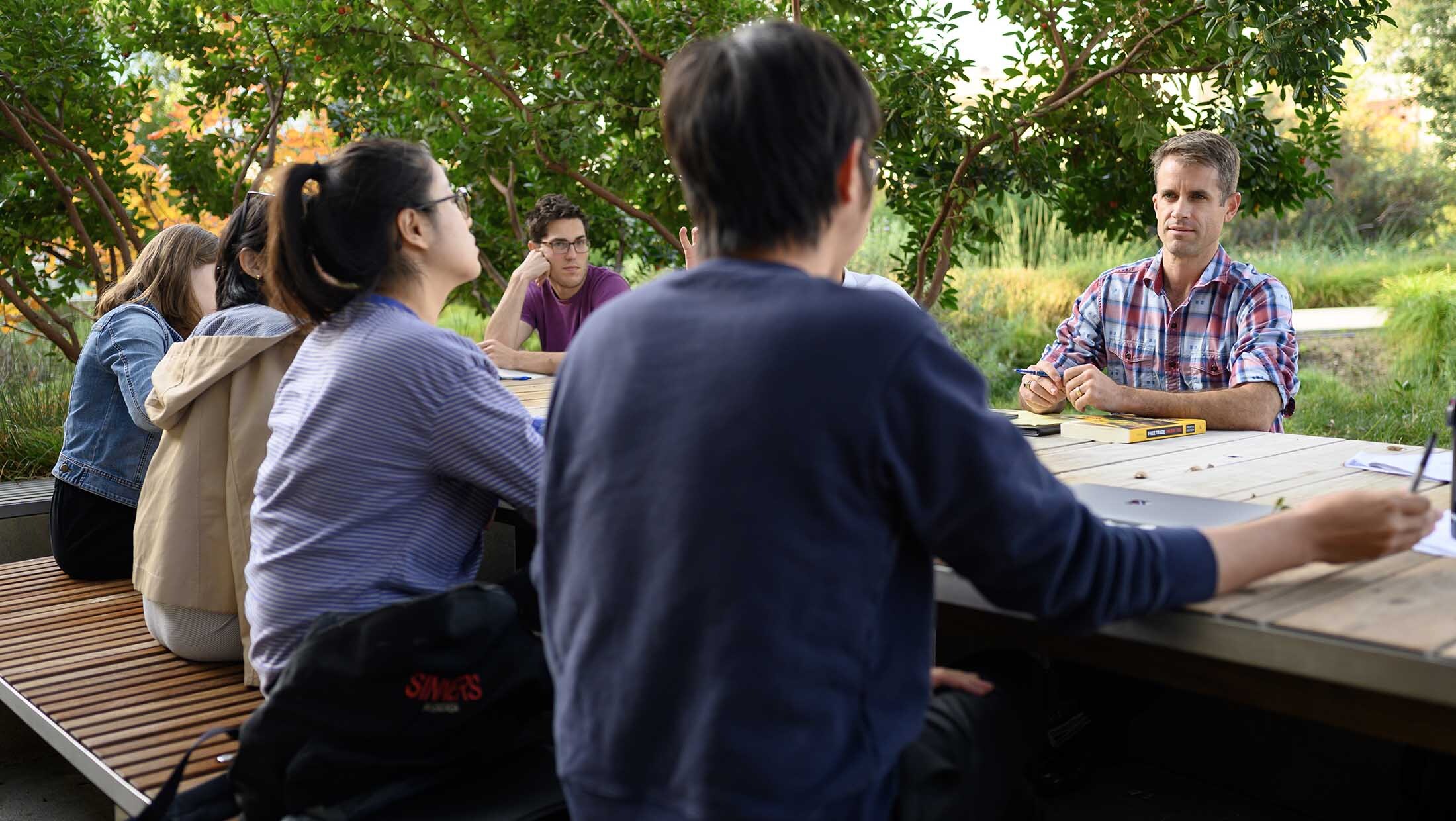Cameron Shelton and students at a table