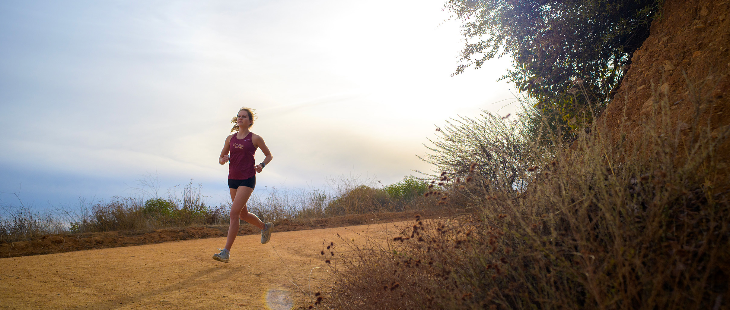 Riley Capuano ‘26 jogging on a mountain trail.