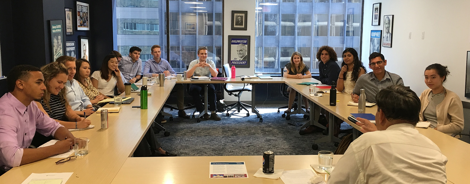 Student interns listening to Treasury Department Senior Economist Nasir Khilji.