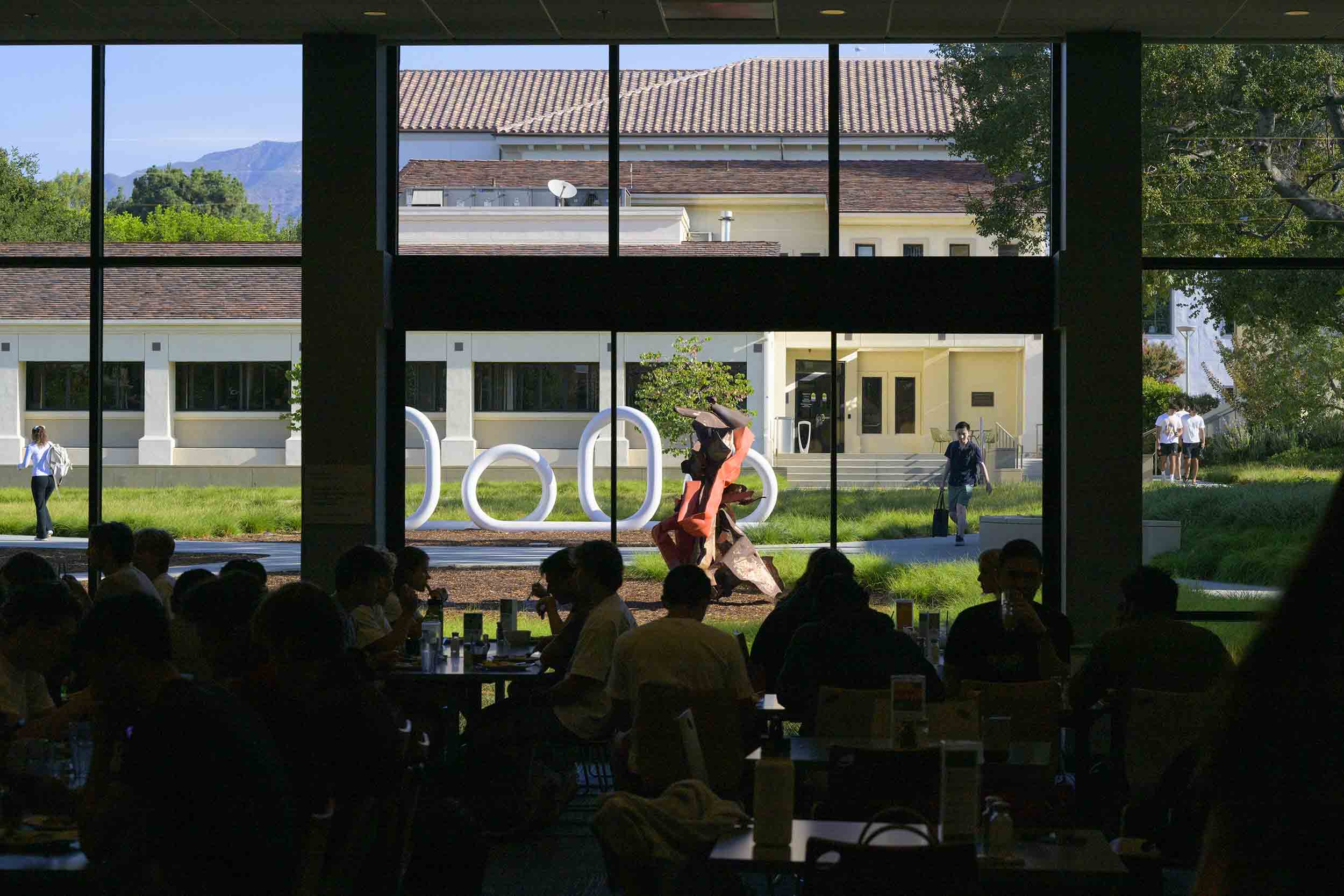 Silhouetted shot through Collins Dining Hall to the 'Loops' art installation.