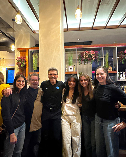 President Chodosh, Erica Jasper (far right) and students at a NCAA convention.