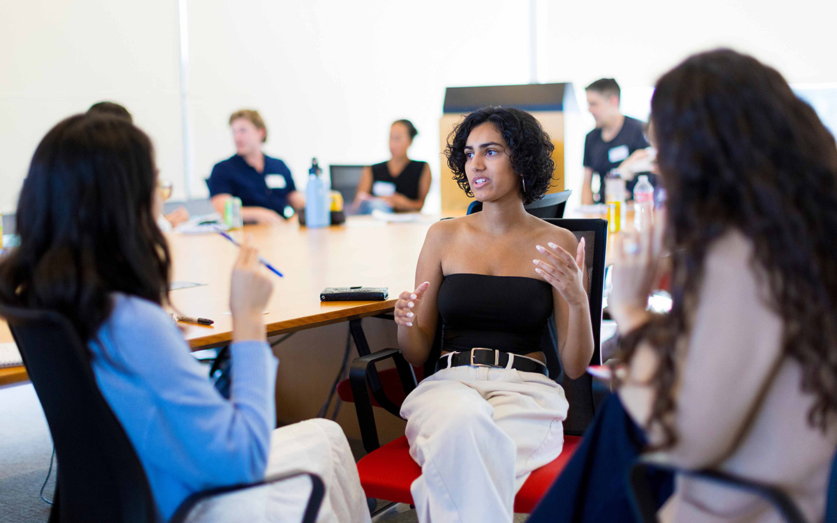 Three Open Academy students in discussion.