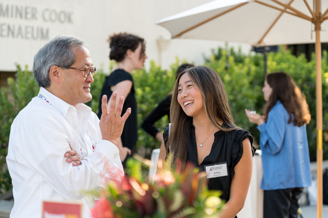 A student and alumni speak during an alumni event.