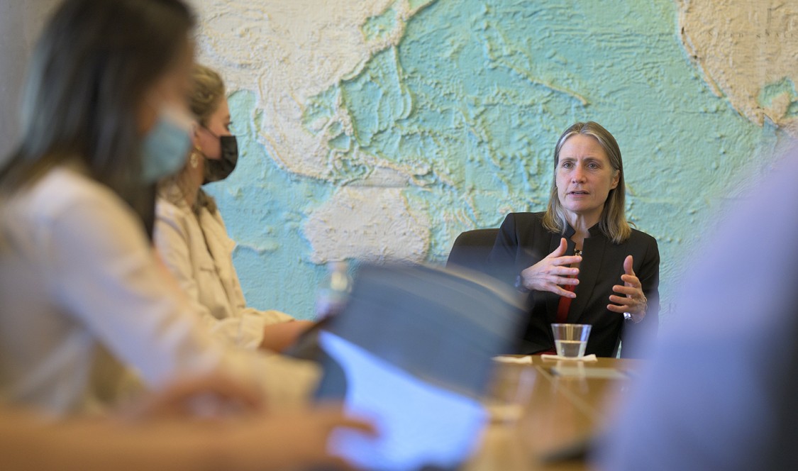 Students take notes on their laptops as Fiona Hills speaks at the head of the table.