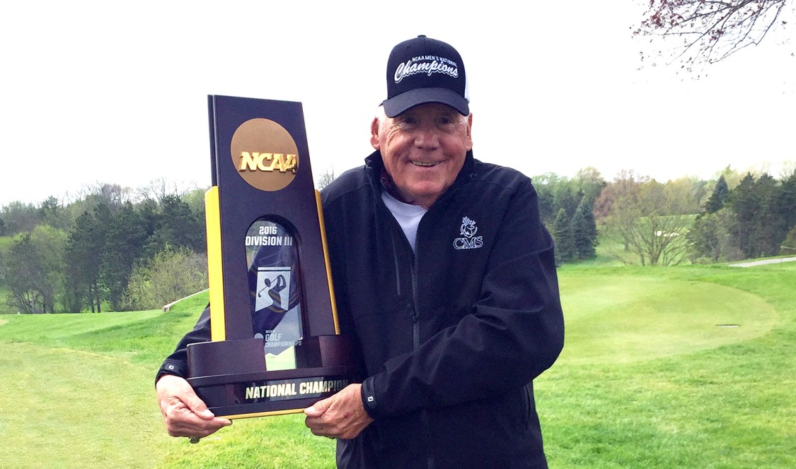 Coach Raymond “Bim” Jollymour holding trophy.