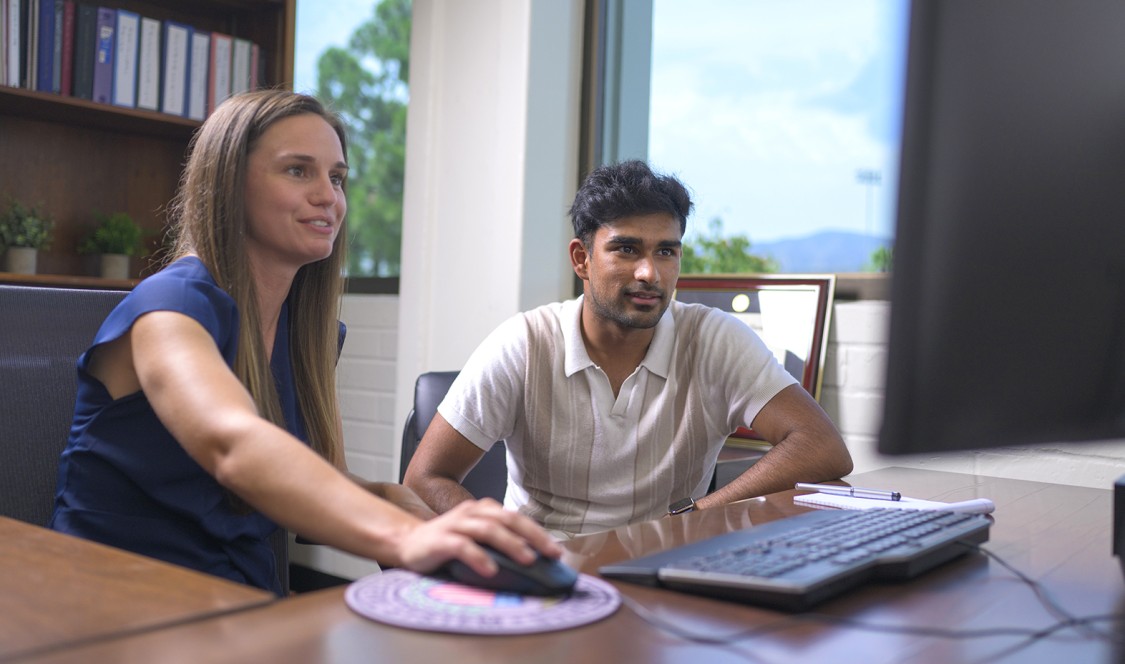 Professor Vossmeyer (left) navigates her office computer while Somu Amujala ’23 (right) observes.