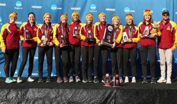 CMS Athenas Cross Country pose on the winner's podium with their NCAA runner-up trophy.