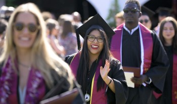 CMC soon-to-be graduates proceed into the tent, waving to families and friends along the way.