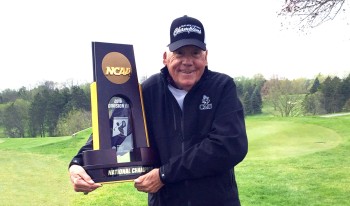 Coach Raymond “Bim” Jollymour holding trophy.