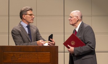 Pres. Hiram Chodash and Prof. John Roth at podium