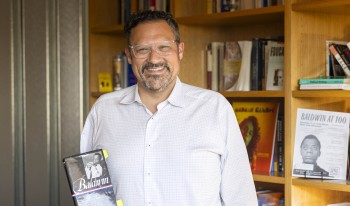 Prof. Buccola in front of a bookcase