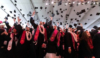 Students throwing caps in air at Commencement 2025