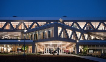 The Robert Day Sciences Center illuminated at night.