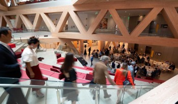 People walking down stairs to trustee lunch at RDSC opening