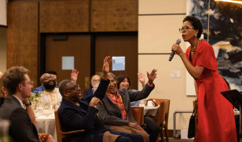 Dr. Diane White-Clayton in front of audience in the Ath