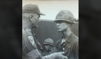 Black and white photo of Gilbert Ferrey '64 receiving a military award.