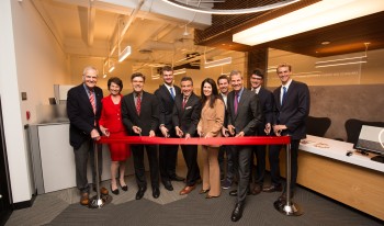 Individuals gather to cut the ribbon at the Soll Center dedication.