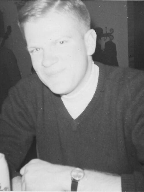 Man in black sweatshirt sitting with black watch on left wrist.