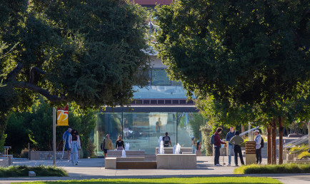 A candid snapshot of students on campus, in front of the Kube.
