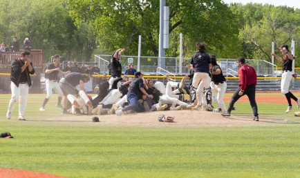 The CMS men's Baseball celebrating on the field after their victory.