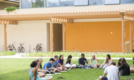 Students meeting on the Gann Quadrangle in front of the Kravis Center.