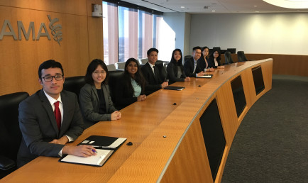 CMC students in the board room of a company in Chicago during their trip