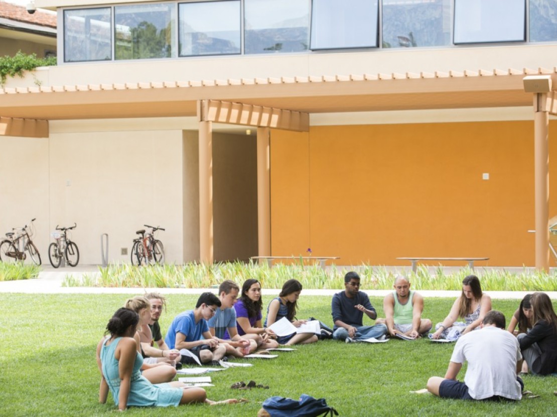 Students meeting on the Gann Quadrangle in front of the Kravis Center.